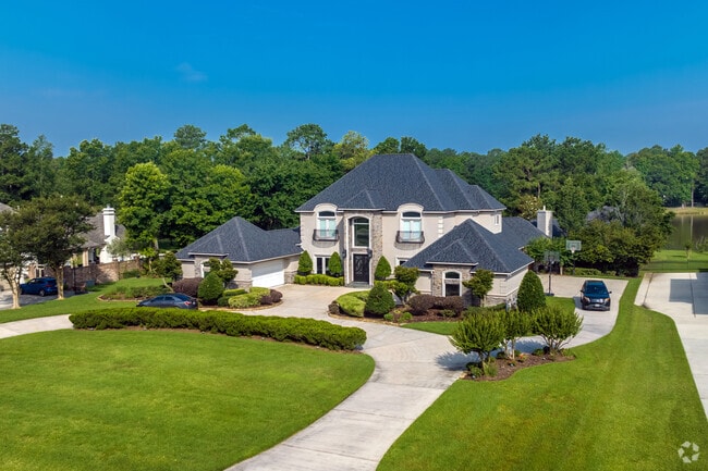 A two-story, French-style Millennial mansion with beautiful landscaping in Benders Landing.