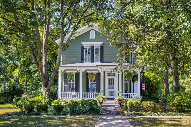 Historic home with a large patio and black window shutters located in Downtown Geneva.