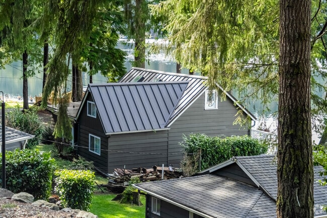Lake Roesiger homes are tucked under massive trees, lots of green spaces and water views.