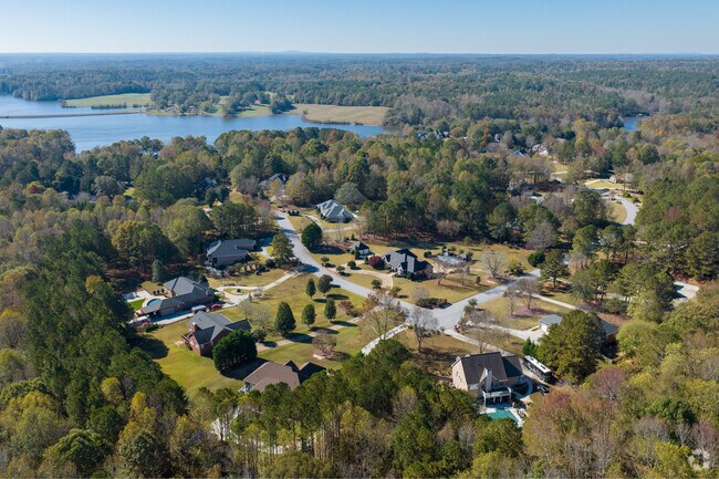 Aerial views of Abilene reveal stunning homes nestled amidst serene lakes & tall forests.