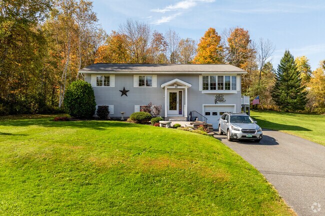 Split-level home in East Barre with spacious yard and garage, offering functional design for families seeking Vermont’s suburban comfort.