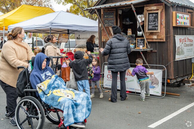 Children enjoy chocolate samples at the Tuesday afternoon Farmer's Market near the Waterfront neighborhood at Lucchesi Park.