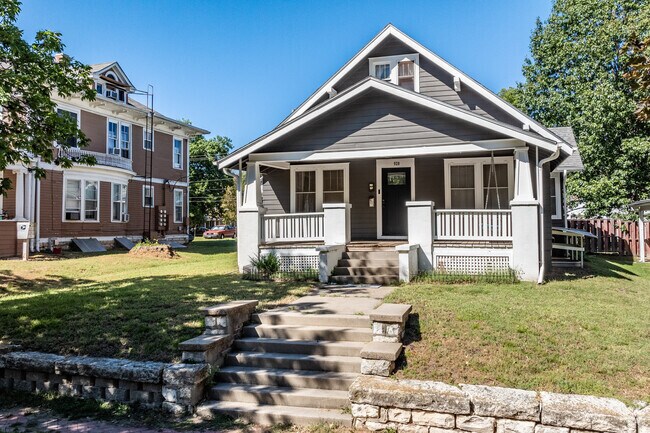 Four square style homes with covered front porches are commonly found in South Manhattan.