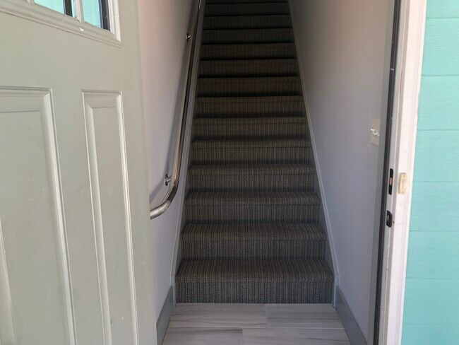 Entryway and stairs leading to unit
