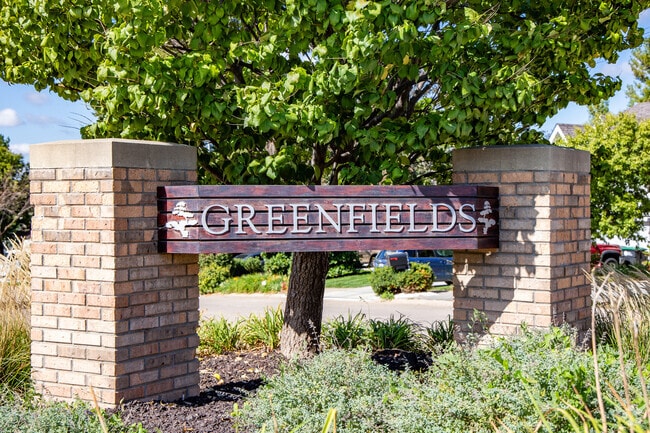 Greenfield features a classic Midwest suburban aesthetic amidst rolling hills and mature trees.