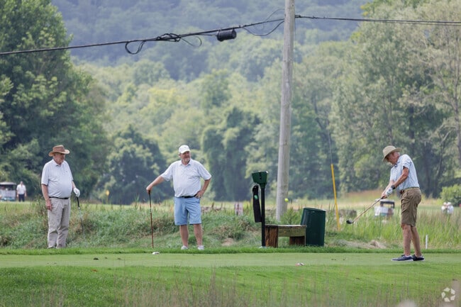 Golfers enjoy the Tuxedo Club golf course on a hot summer day.