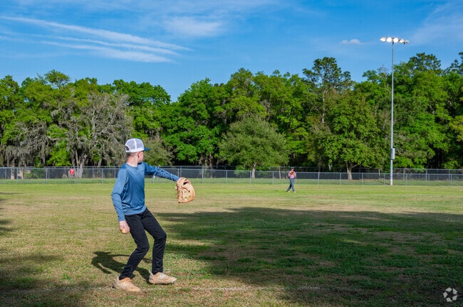 Players stretch out and warm up for practice at Ridge Manor Baseball Fields.
