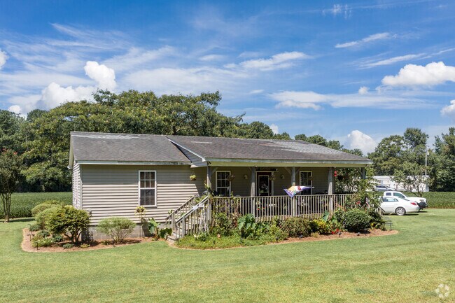 A coastal cottage with a large front porch in the Knotts Island neighborhood of North Carolina.