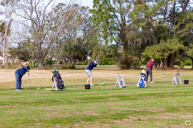 Golfers enjoy the practice range at Roger Park Golf Course near Rainbow Heights.