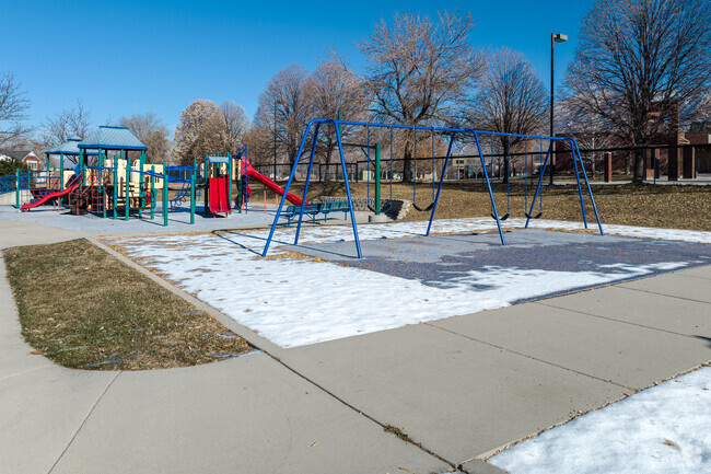 A blue swing set faces Jordan Valley School’s colorful playground.