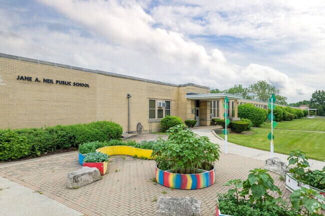 Neil Elementary School has a lovely front entrance with shrubs and planters.