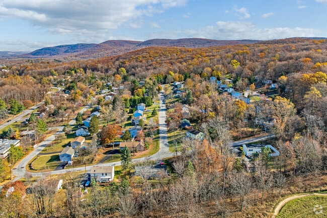 Warm fall landscape beautifully covers homes on a hill in Vernon, NJ.