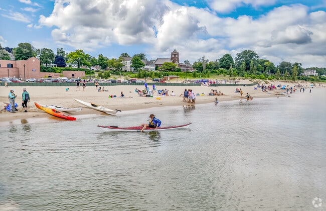 Bathers and kayakers enjoy a day at South Beach in South Haven.