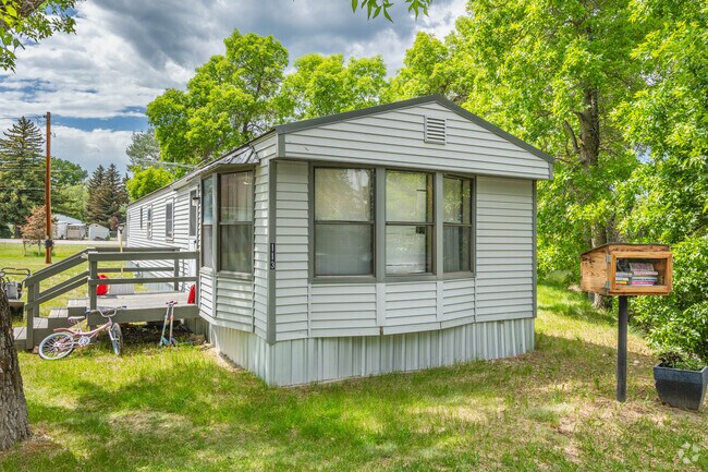 Manufactured homes are common in Roberts and some have decorations like a Little Free Library.