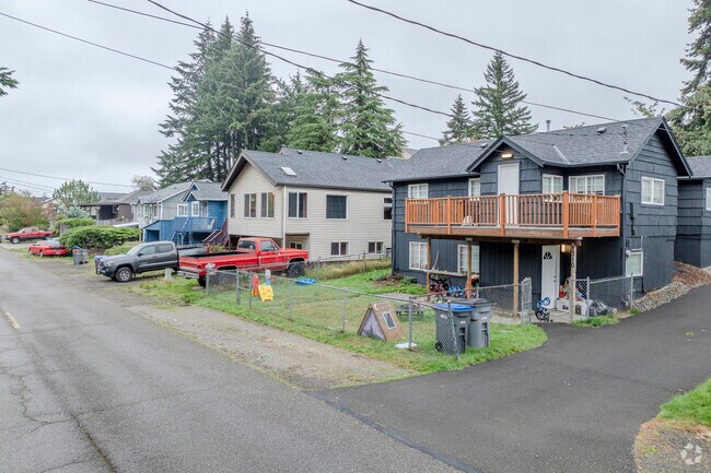A row of traditional style homes line the street of Piondexter Ave W in Pixie Park WA.
