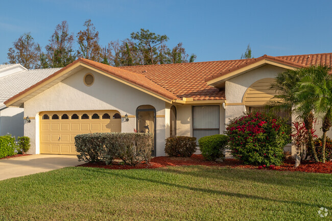 Single-story ranch home with Mediterranean style barrel tile roof.