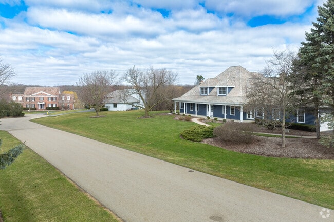 Housing includes Colonial influenced multistory homes with an abundance of greenery around.