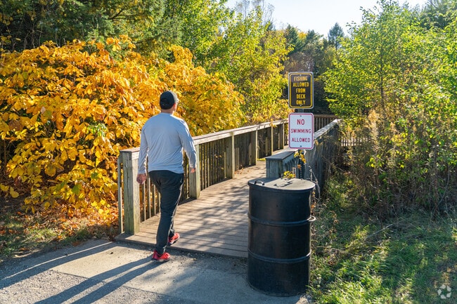 A Normal, IL resident utilizes the walkway to the fishing pond at the Fransen Nature Area.