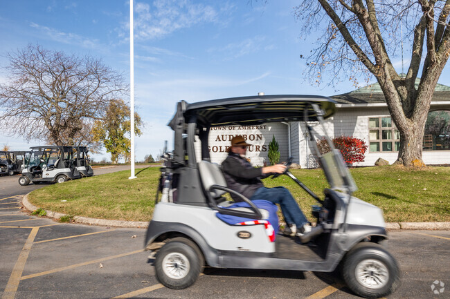 A man drives to the greens in his golf cart at Audubon Golf Course in Amherst, NY.