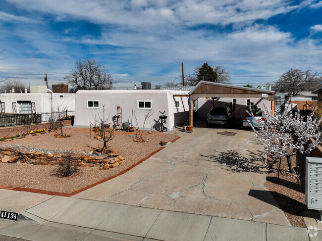White adobe style homes can be found in Hodgin with unique carport.