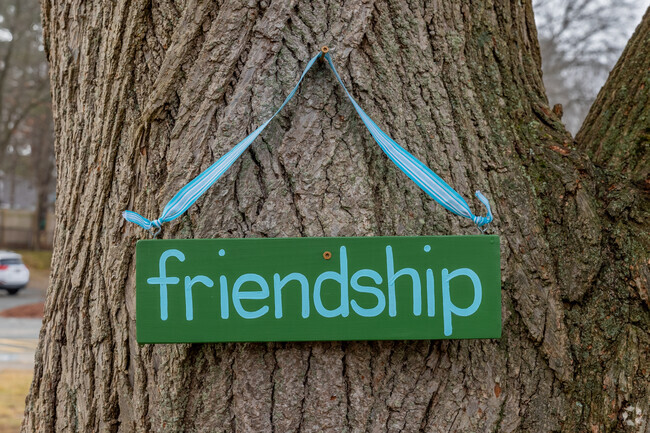 A friendly sign rests on a tree at Frederick C Murphy in Weymouth.