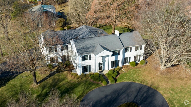 Colonial revival home in Indian Hills with a wrap around driveway.