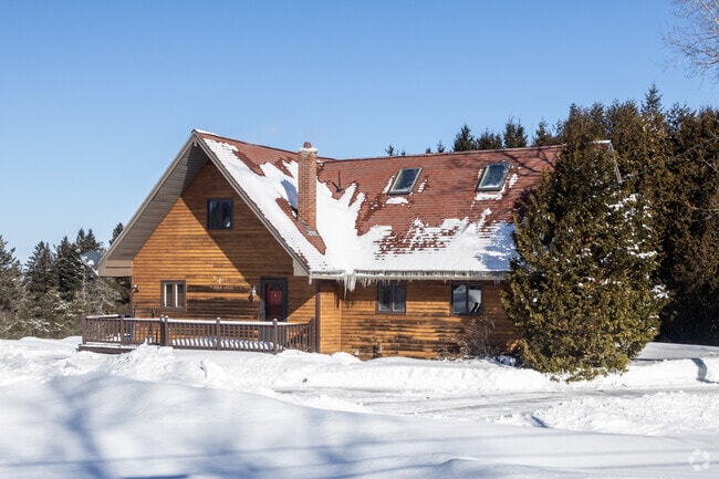 This rustic home can be found on the outskirts of Presque Isle, where the scent of pine and damp earth permeates the air, and the quiet rustle of pines provides a serene backdrop to its weathered wooden walls.