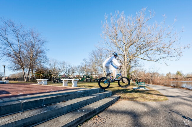 Cyclists ride along the scenic pond trail at Grant Park in Hewlett.