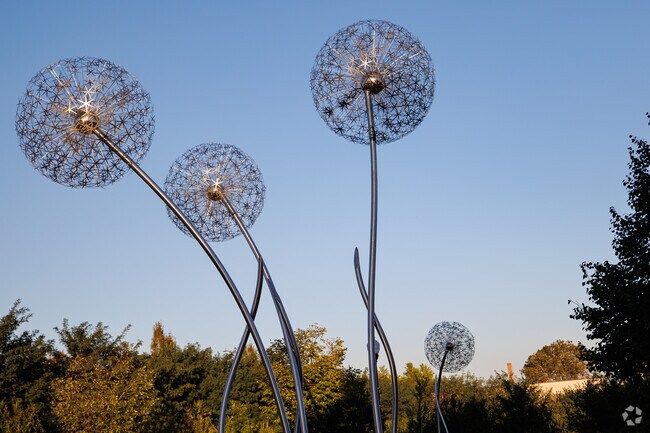 Dandelion sculptures by David Tonnesen mark the Edmondson Village entrance.