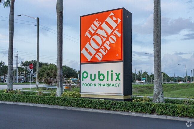 Shopping center near Lake Belvedere Estates with Home Depot and Publix signage.