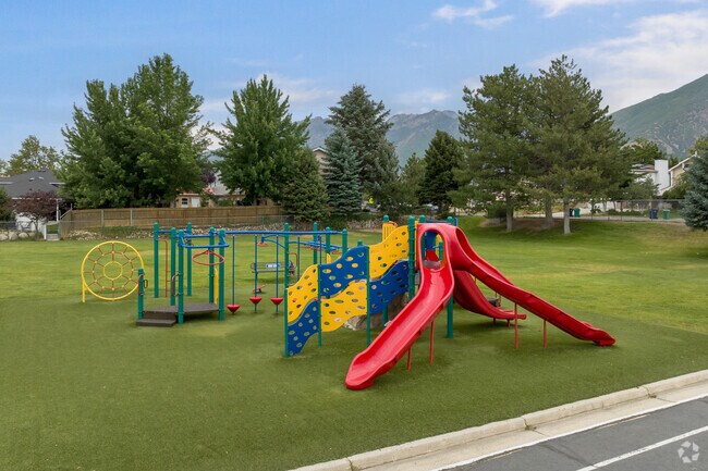 A colorful playground on a green lawn at Quail Hollow Elementary School.