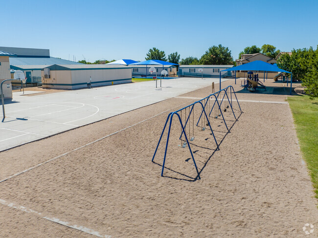 The Augusta Ranch Elementary School playground features swings.