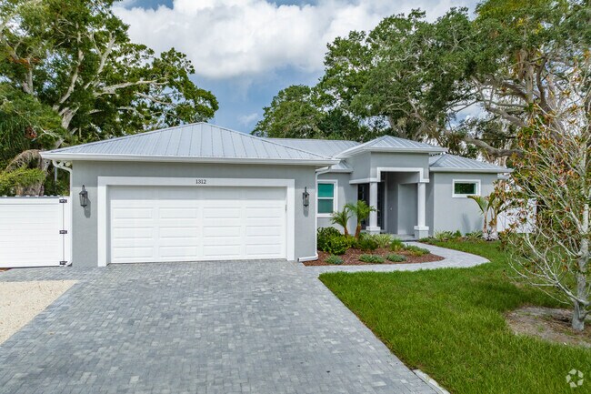 Homes in Arlington Park feature paver driveways with garages.