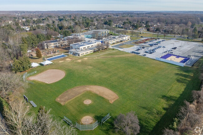 There is a playground and open field with a baseball diamond at Krieger Schechter Day School.