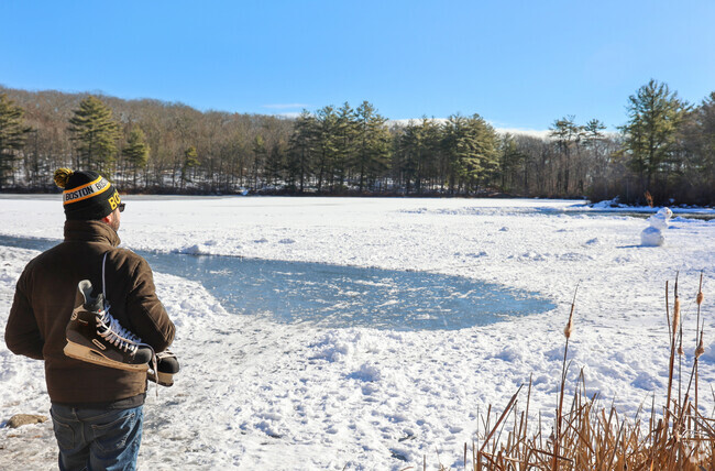 Locals take to West Pond in Magnolia for a winter day of pond hockey and building snowmen.