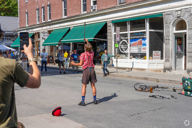 A street performer balances knives on his face during Taste of Montpelier event near The Meadow.