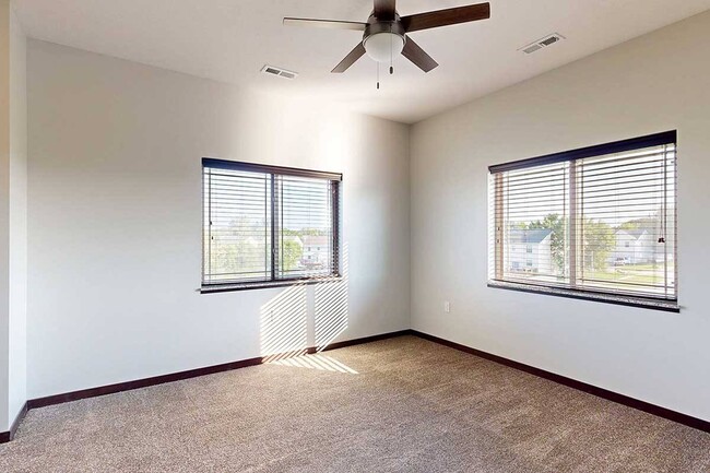 Enjoy a spacious bedroom with large windows that let in plenty of natural light.