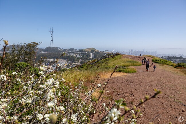 Family hiking with a view of San Francisco from Mt. Davidson in Miraloma Park.