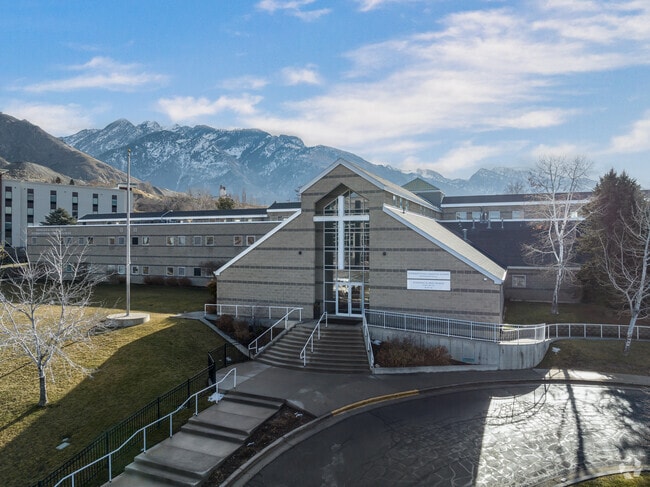 A white cross on an oversized window marks the entrance of Intermountain Christian School.