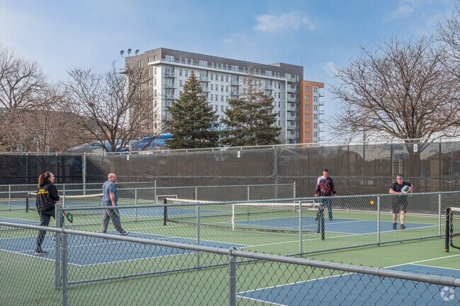 People playing Pickleball at the local court in Wolfe Park.