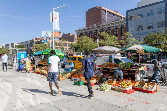 Locals shop and walk through Astor Row visiting vendors along the way.