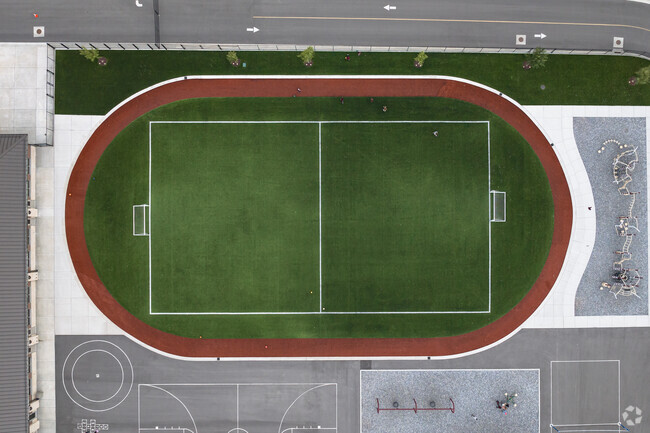 A soccer field surrounded by a track at Challenger School.