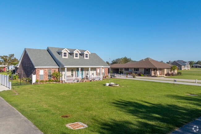Cape Cods can be found alongside ranches , all of which have spacious front yards.