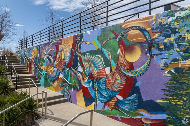 A colorful wall mural adorns a wall in Memorial Park.