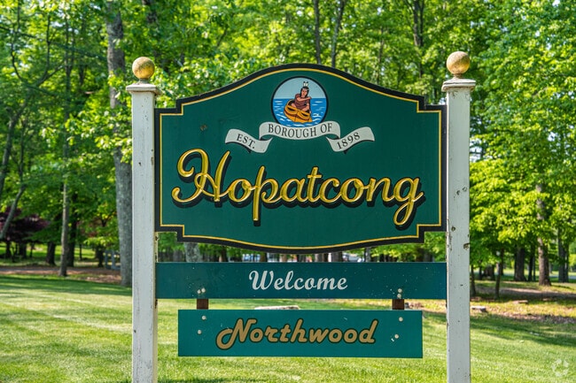 Lake Hopatcong sign surrounded by trees.