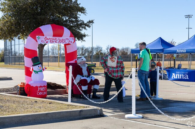 Kids can take a picture with Santa in Anna's Christmas Market and Parade