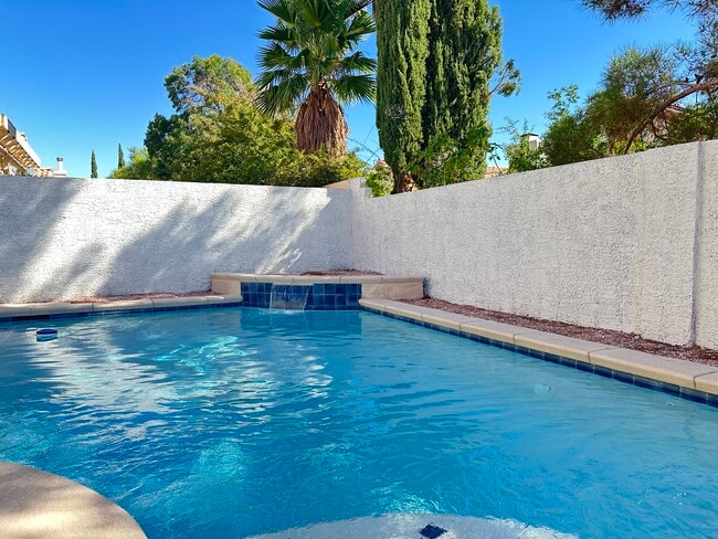 Pool with small landing, solar heat, water feature and color changing LED light.