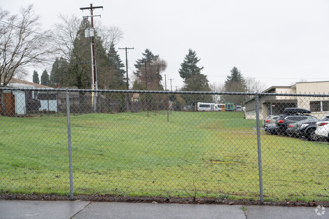 A grassy recreational area sits to the south of the campus.