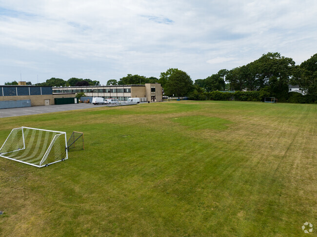 Play soccer in the back of Beach Street Middle School on the green field.