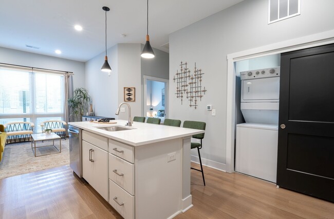 Quarry Trails Model washer/dryer, island kitchen and living room